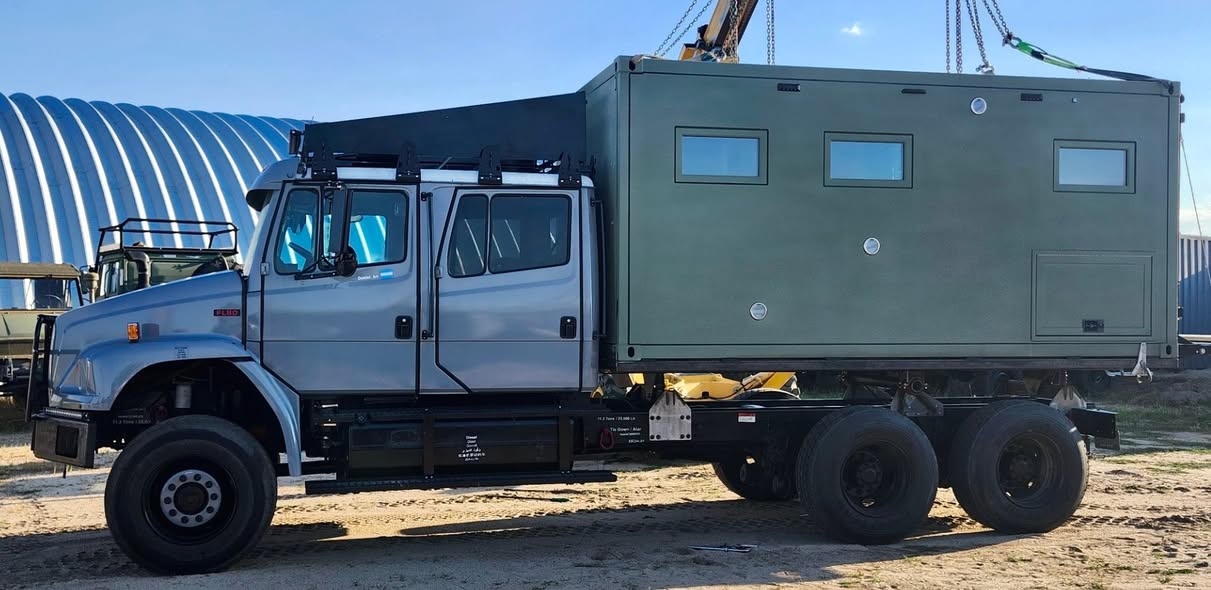 Crane installing the living module on the Overland Americas Freightliner